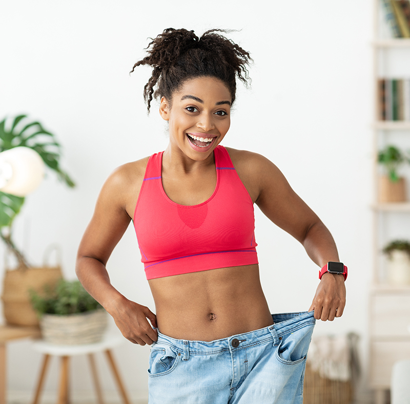 Excited Girl Wearing Too Big Jeans After Weight Loss Indoor